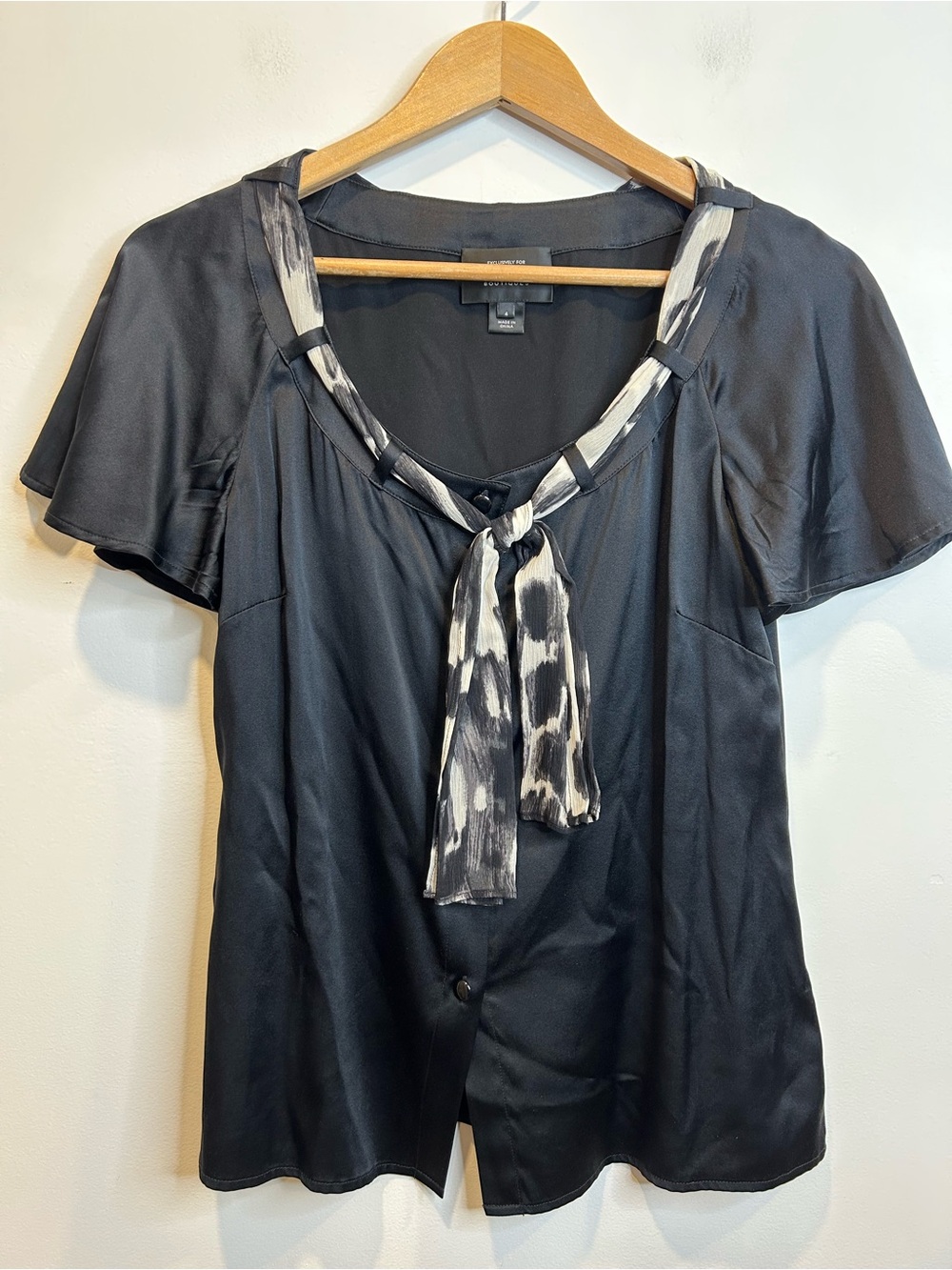 St. John blouse buttoned V-neckline with black-and-white animal print silk tie